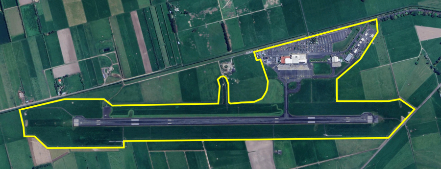 Aerial view of Dunedin Airport and surrounding area, with ICA boundary outlined in yellow