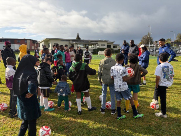 Tottenham Hotspur running a football clinic with recently arrived refugee children and young people.