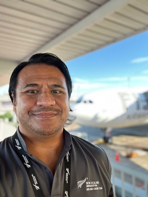 Aubrey Tupai Creagh stands in front of airplane