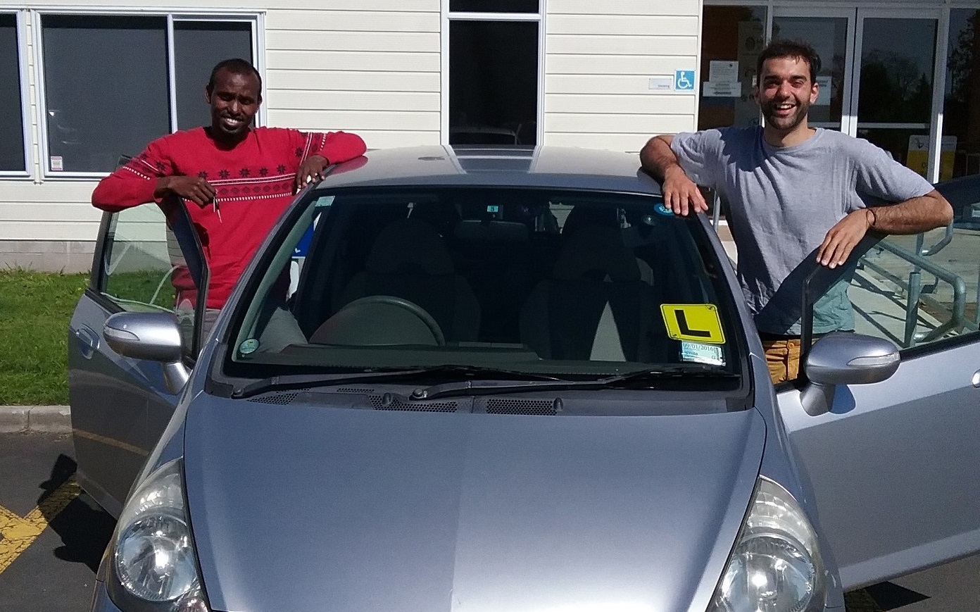 Two people with a car.